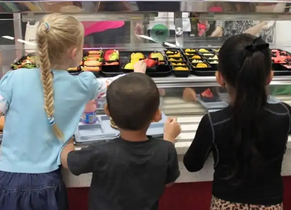 Student selecting food tray