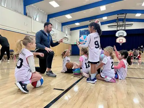 Youth basketball players with coach