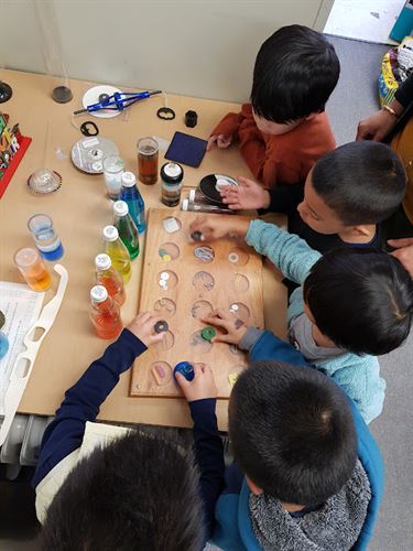 Students exploring various items to see which on is magnetic.