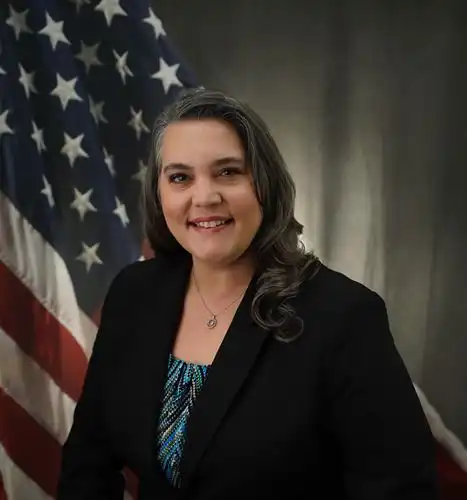 Woman in front of a flag