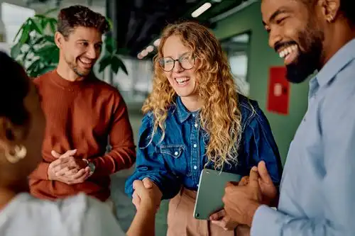 female shaking hands with colleagues