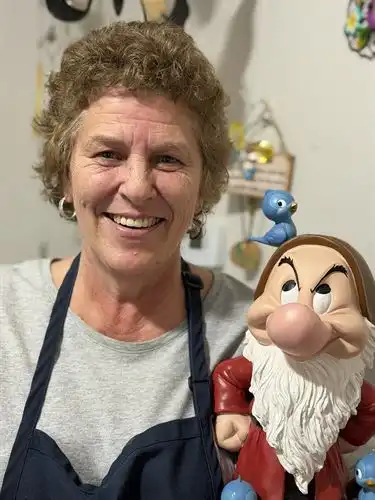 adult holding grumpy dwarf