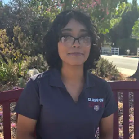 Female student profile picture sitting on a bench wearing  gray Chap Vista High school polo.