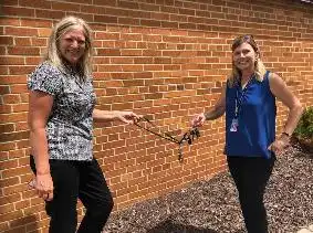 Michelle Otis hands the keys over to Carol Hayes.