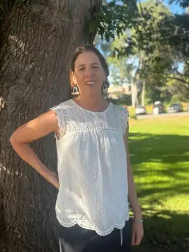 Director of Migrant Education, Trish Unruhe, standing outside by a tree.