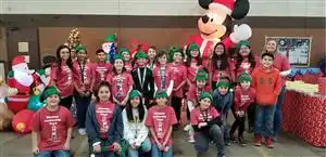 A group of students caroling during the holidays.
