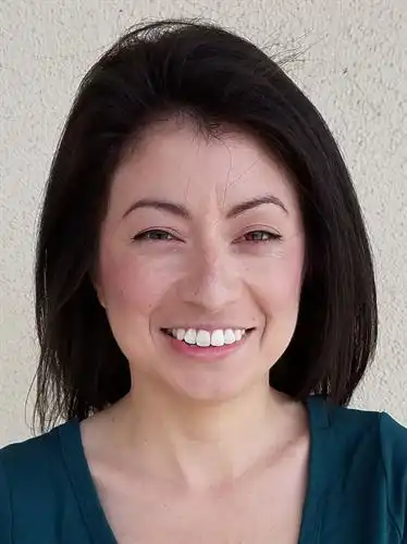 smiling woman with dark hair and eyes white background
