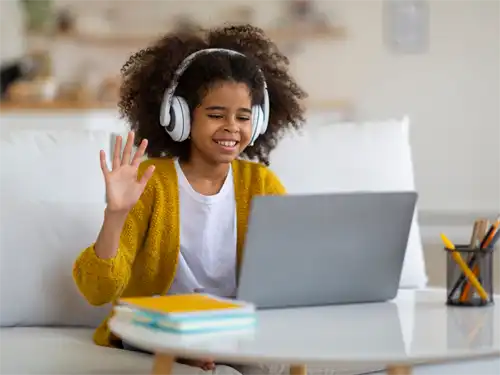 girl on lap top raising hand