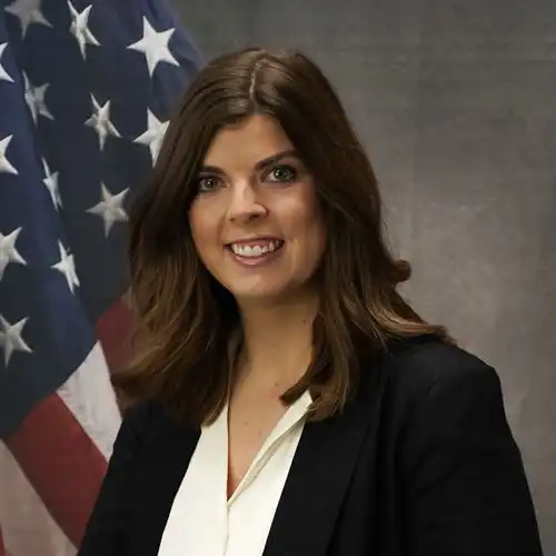 Woman in front of a flag