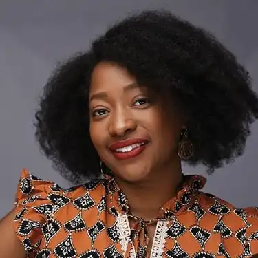 Woman with curly hair smiling for photo