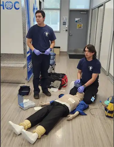 Two EMT students listen as instruction is given