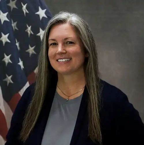 Woman in front of flag