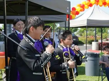 Two young boys sing during the mariachi performs by Liberty Charter at ArtsFest