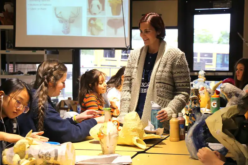 students smiling at teacher in classroom