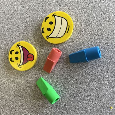 Erasers: circular smiley face and pencil top