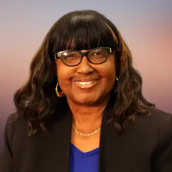 woman with glasses smiling