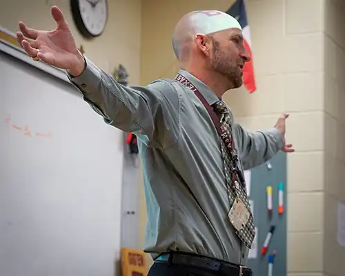 churchill teacher spreading his arms