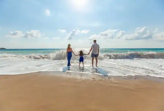 Family at the beach playing in the water