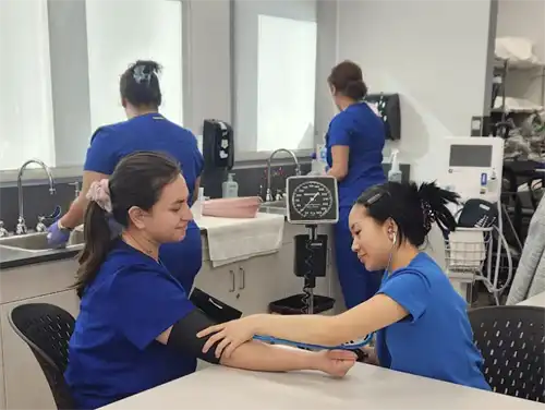CNA students learn how to use blood pressure cuffs