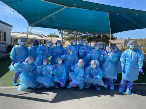 A group of pharmacy tech students pose in their PPE