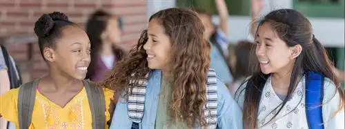 students smiling in the hallway