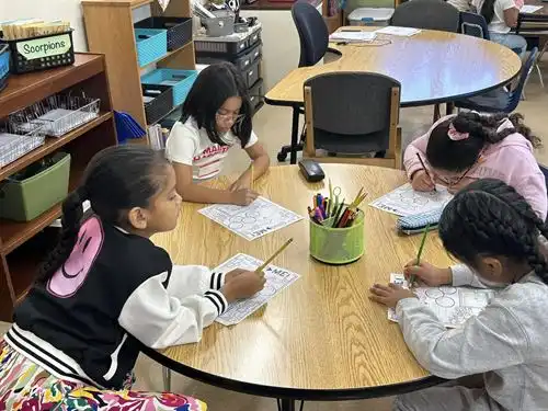Students sitting around table