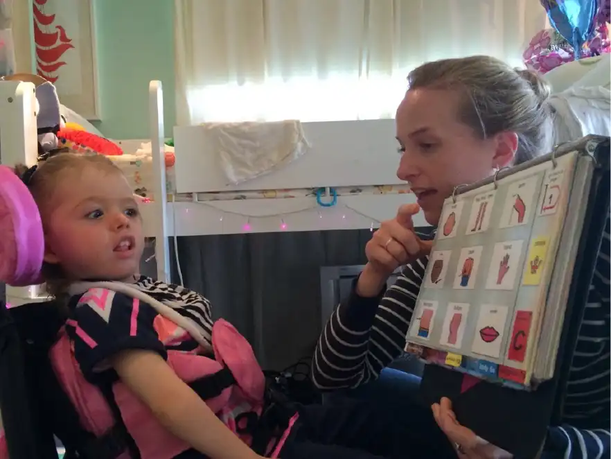 Emerson and Ali using a PODD book