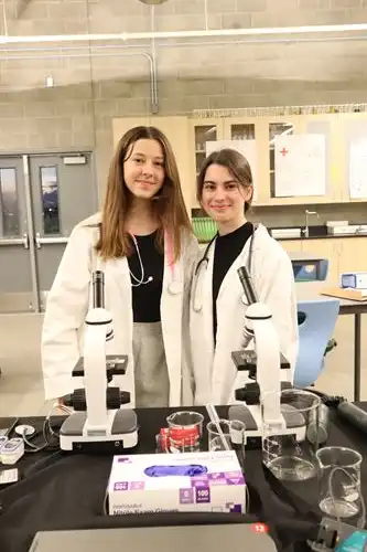 two students in lab coats