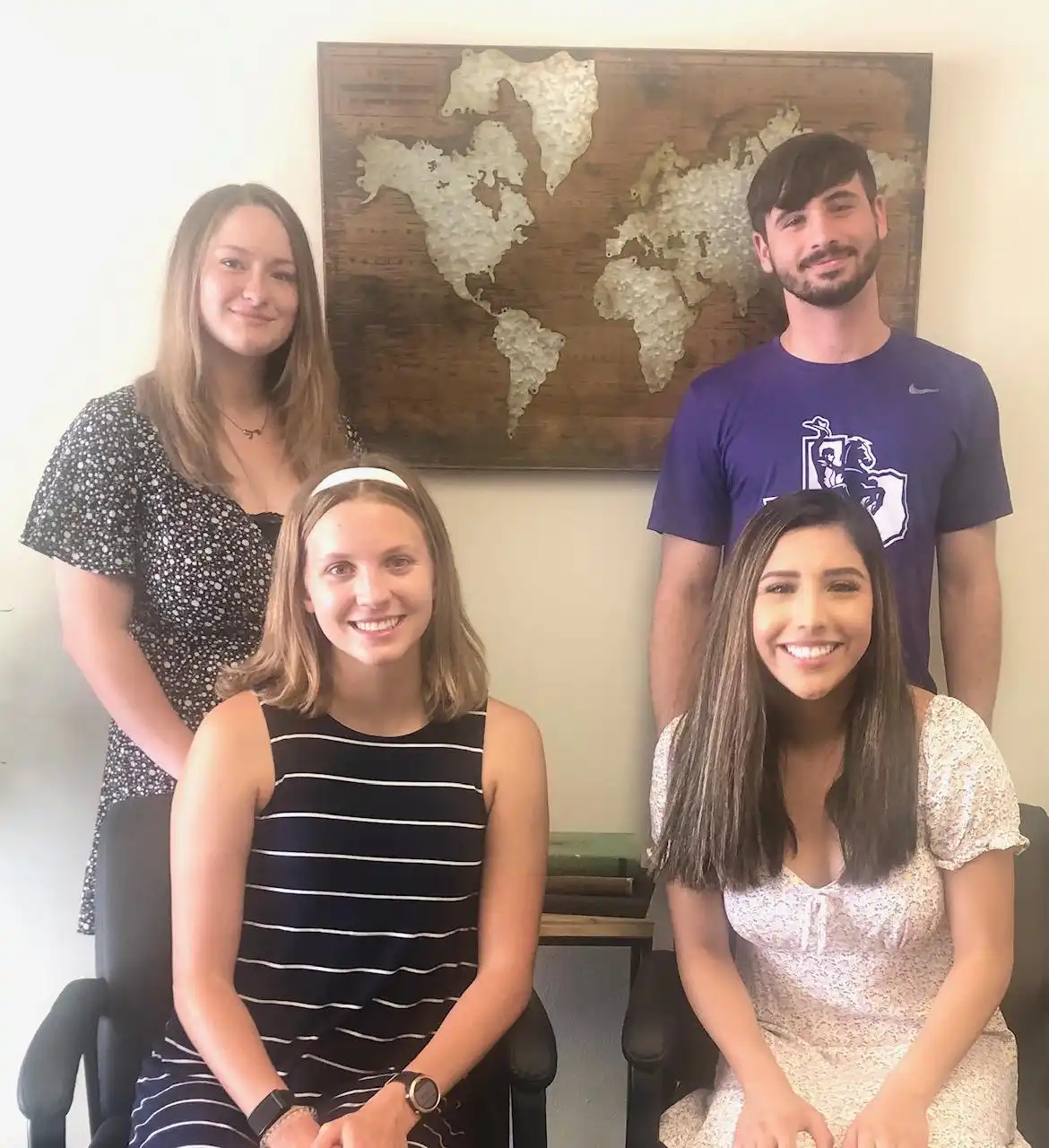 group of students in front of map
