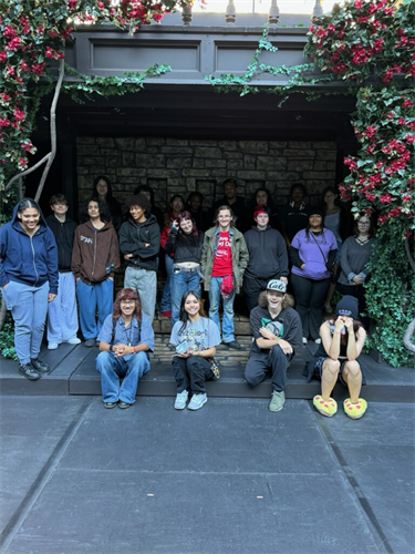 students posed on staircase